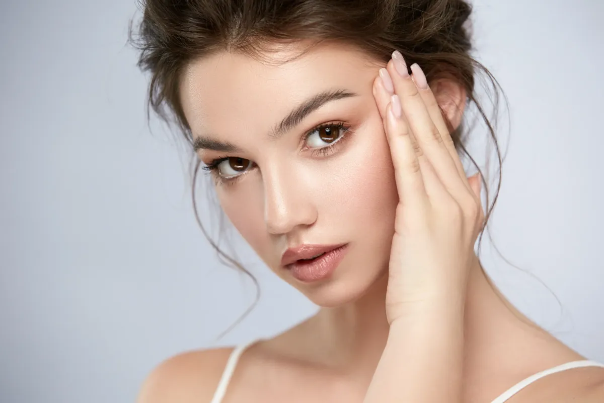 a woman with her hand on her face
