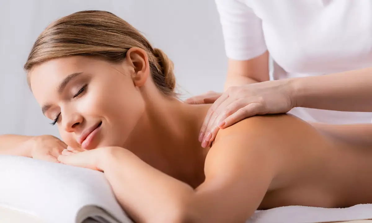 a woman lying down on a massage table