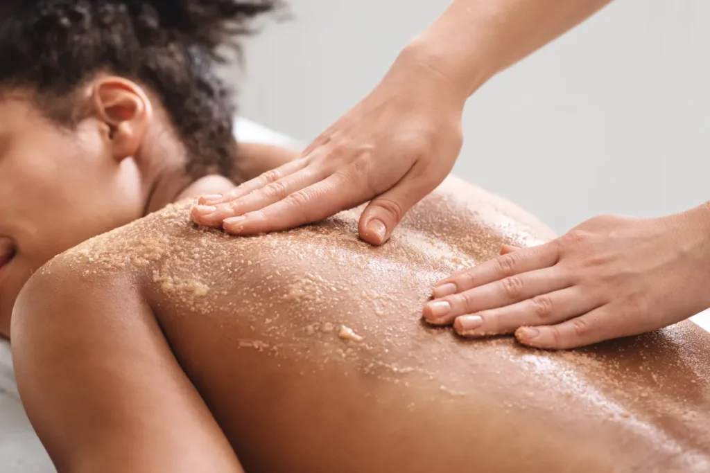 Portfolio a person receiving a scrub on a woman's back
