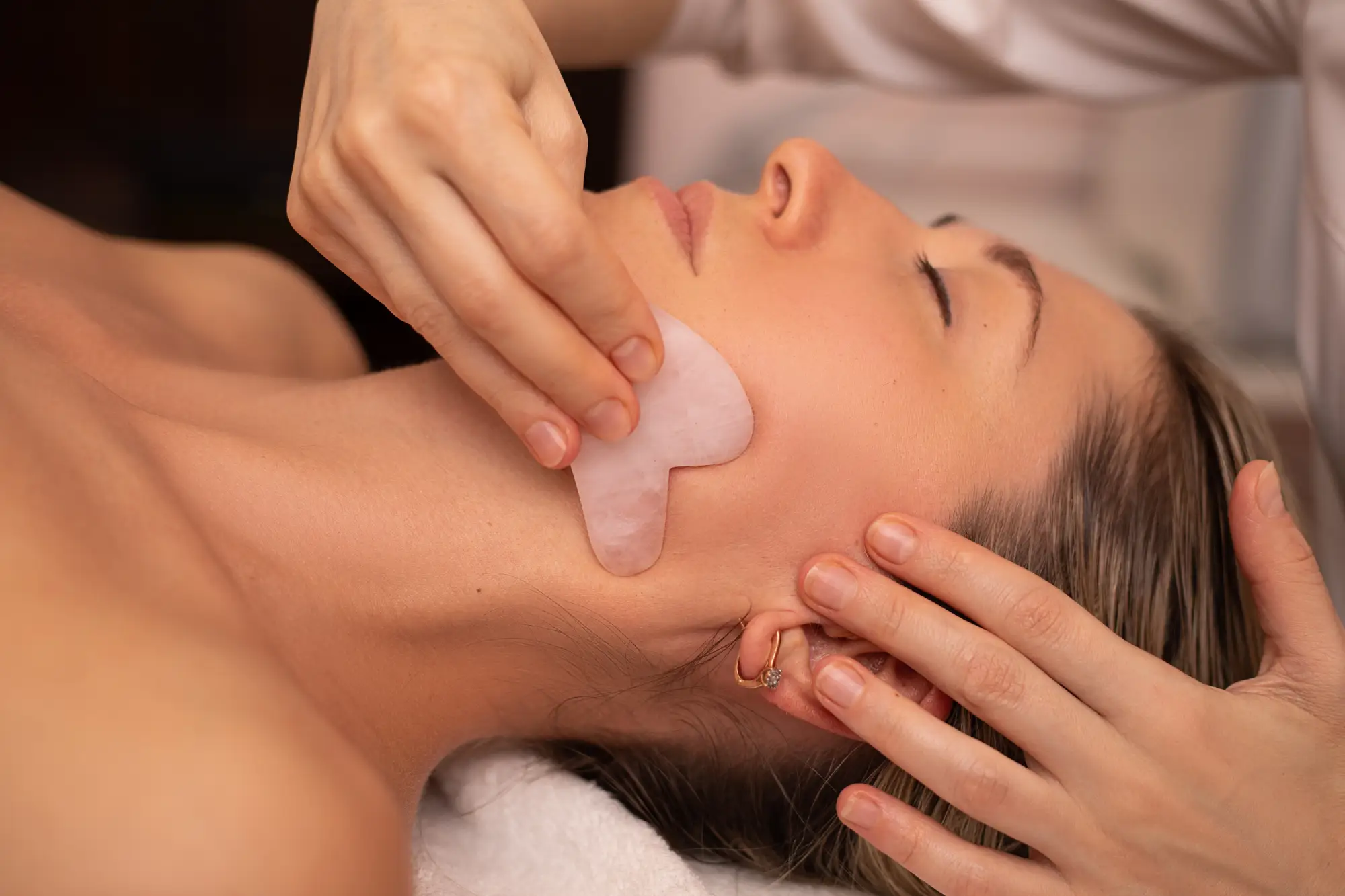 a woman receiving a face massage