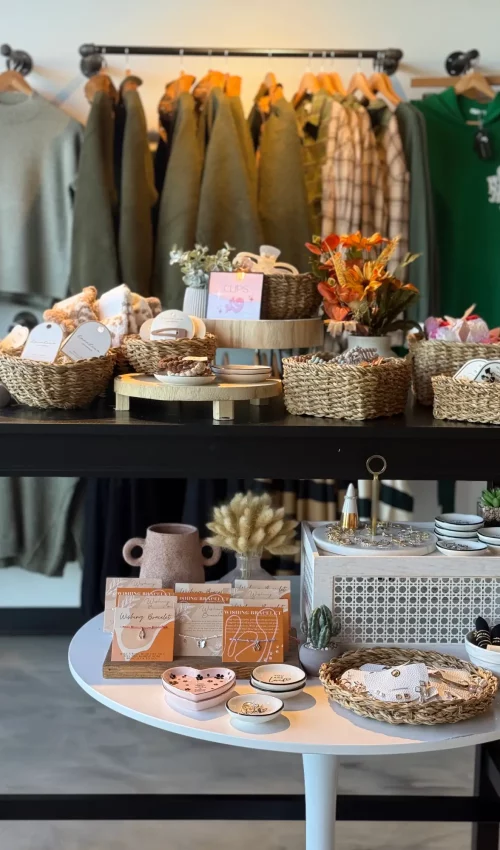 a table with baskets of jewelry and flowers